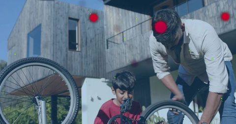 Father and Son Repairing Bicycle Together Outside Modern Wooden House Teaching DIY Skills