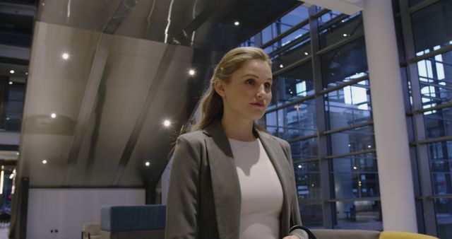 Businesswoman in Modern Office Building with Large Windows - Download Free Stock Images Pikwizard.com