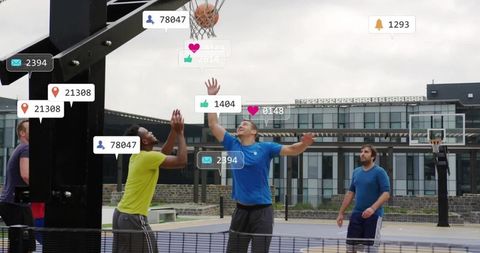 Players jumping for basketball with social media notification overlays on campus court