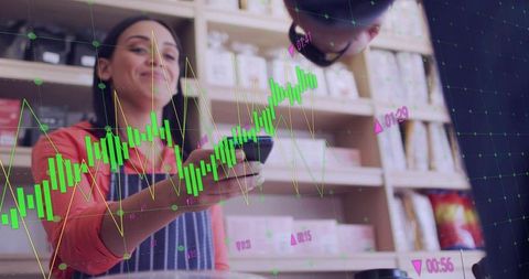 Clerk handing card terminal while customer tapping phone with real-time sales data overlay