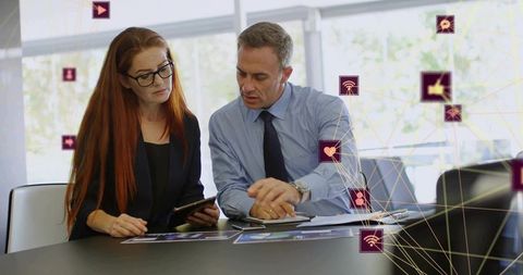 Professionals collaborating and analyzing tablet data with digital network icons overlay