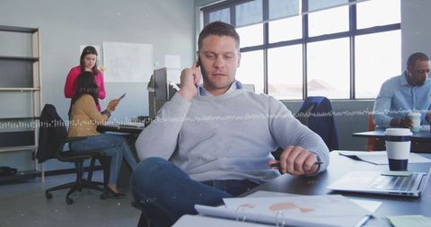 Professional Man Discussing Business on Phone in Modern Office