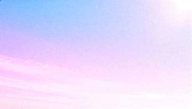 Pastel sunrise sky gradient with soft sun flare and airy cloud streaks