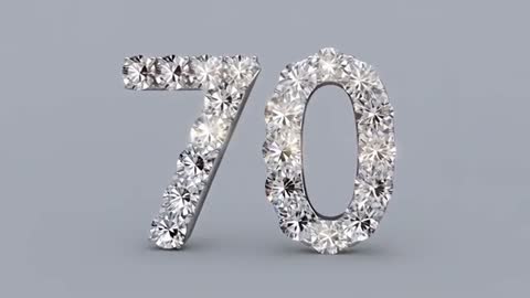 Rotating diamond-encrusted 70 numeral sparkling on neutral gray floor