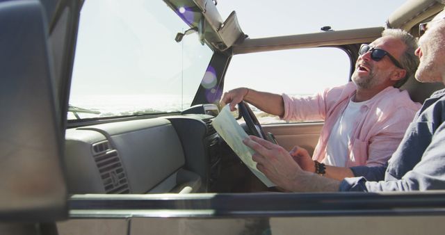 Two friends enjoying a road trip in a convertible car under bright sunlight. One of them is holding and reading a map while both are laughing and having a good time. This image is perfect for use in travel brochures, vacation advertisements, blog posts about friendship or summer activities, and promotional content related to road trips or outdoor adventures.