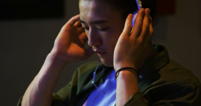 Close-Up of Young Man Listening to Music with Headphones - Download Free Stock Images Pikwizard.com