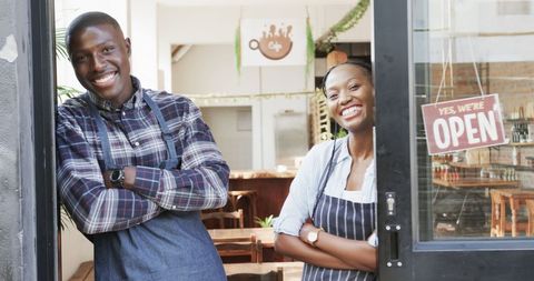 Smiling Black Coffee Shop Owners Welcoming Customers