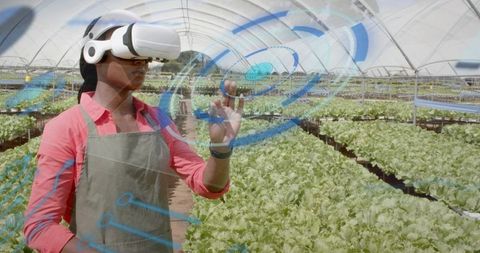 Technician Using VR in Greenhouse for Precision Agriculture