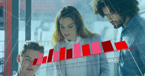 Team Analyzing Data Graph on Large Glass Surface in Modern Office