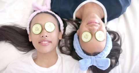 Teen Girls Relaxing with Cucumber Masks at Home Spa Day - Download Free Stock Images Pikwizard.com
