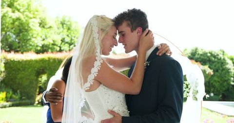 Happy Bride and Groom Embracing at Outdoor Wedding Ceremony