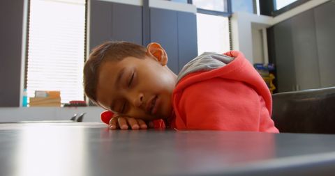 Schoolboy Resting in Classroom During Lesson