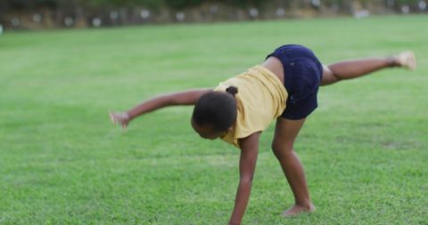 Girl Playing Outdoors Doing Cartwheel on Green Grass - Download Free Stock Images Pikwizard.com