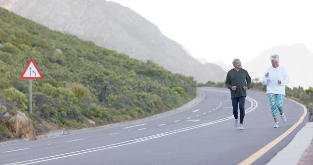 Senior Couple Enjoying Morning Jog on Mountain Road - Download Free Stock Images Pikwizard.com