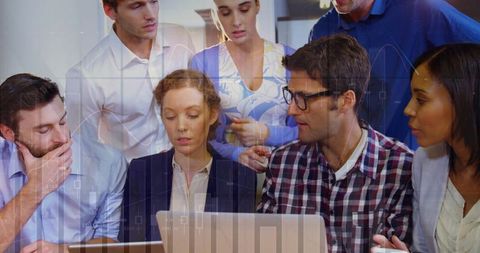 Diverse business team collaborating over laptop and tablet analyzing financial charts and dashboards