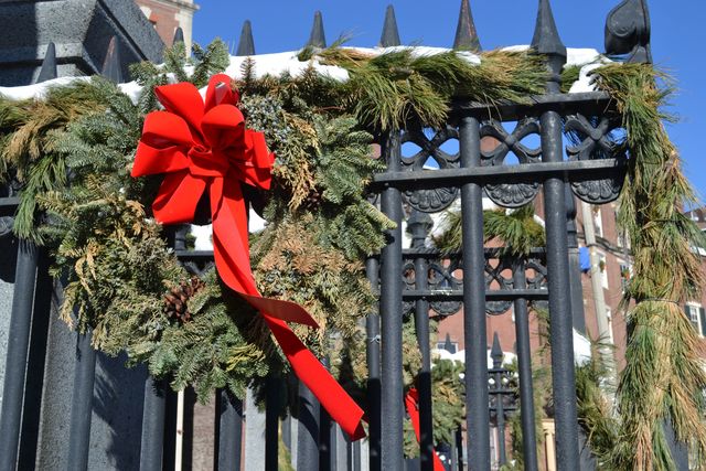 Festive Wreath with Red Bow on Iron Gate Outdoors - Download Free Stock Images Pikwizard.com