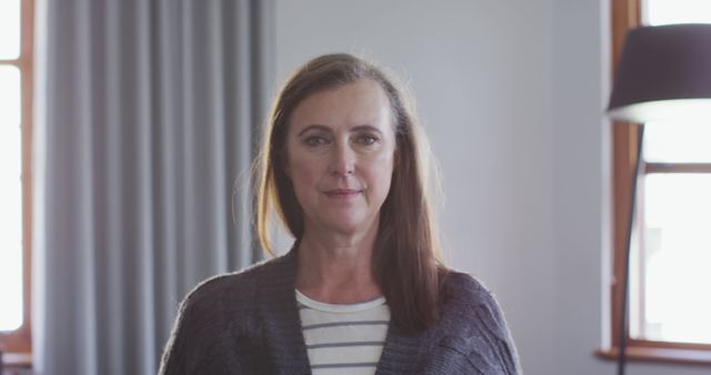 Confident Middle-Aged Woman Smiling Indoors - Download Free Stock Images Pikwizard.com