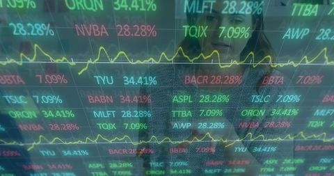 Business analysts monitoring live stock market data on screen