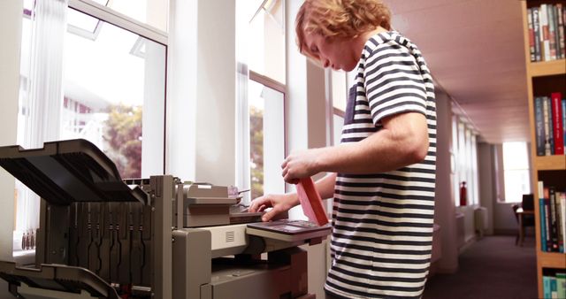 Young Man Using Photocopier in Office Environment - Download Free Stock Images Pikwizard.com