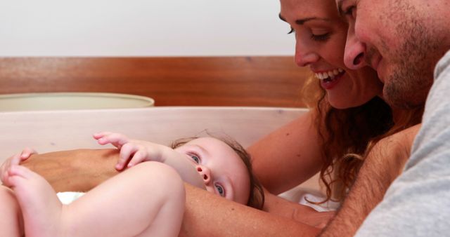 Loving Parents Smiling and Playing with Newborn Baby - Download Free Stock Images Pikwizard.com