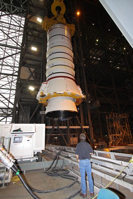 CAPE CANAVERAL, Fla. – In the Vehicle Assembly Building at NASA's Kennedy Space Center in Florida, the Ares I-X aft booster segment with the aft skirt is moved to High Bay 1 where it will be lowered onto the mobile launch platform in High Bay 3.  This is the start of the buildup of the Ares I-X launch vehicle for the flight test targeted for no earlier than Aug. 30.  Part of the Constellation Program, the Ares I-X is the test vehicle for the Ares I, which is the essential core of a space transportation system that eventually will carry crewed missions back to the moon, on to Mars and out into the solar system.  Photo credit: NASA/Jack Pfaller