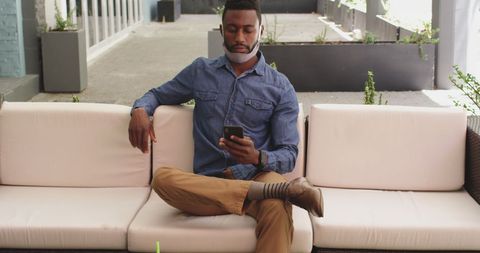 Man in Outdoor Cafe Practicing Social Distancing with Smartphone