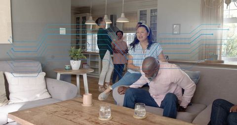 Friends chatting and laughing in modern open-plan living room with digital tech overlay