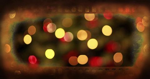 Vintage sepia bokeh vignette with warm cinematic film border and glowing moody orbs grunge