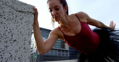 Woman in Urban Fitness Focus Performing Outdoor Stretching - Download Free Stock Images Pikwizard.com