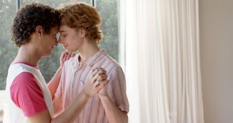 Affectionate Gay Couple Gently Dancing Together at Home
