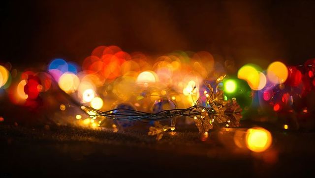 Coiled warm led string casting colorful bokeh orbs and soft ambient holiday glow