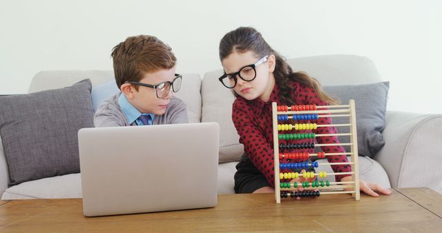 Children Learning Math with a Laptop and Abacus on Sofa - Download Free Stock Images Pikwizard.com