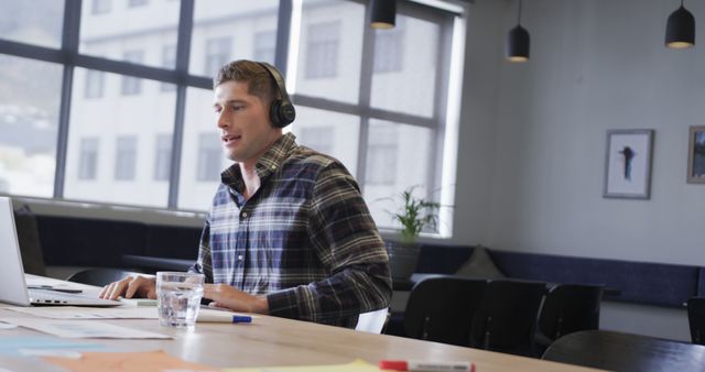 Man Wearing Headphones Conducting Virtual Meeting in Modern Office - Download Free Stock Images Pikwizard.com