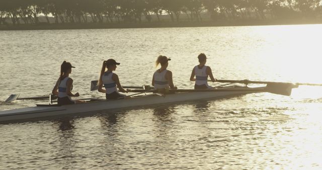 Team of Women Rowers in Boat at Sunrise on Tranquil Lake - Download Free Stock Images Pikwizard.com