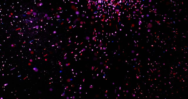 Colorful confetti explosion with glitter detailed against a black background. Ideal for use in celebration-themed designs, marketing materials for festivities, party invitations, seasonal events, and websites promoting fun and excitement. Great for digital graphics, posters, and advertisements highlighting joyous occasions.