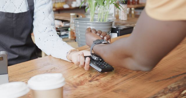 Customer Making Contactless Payment with Smartwatch at Cafe Counter - Download Free Stock Images Pikwizard.com