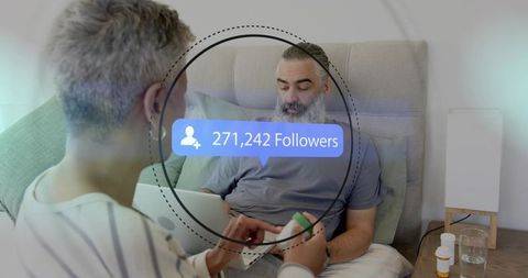 Mature couple caregiving at bedside with laptop, medication management and follower overlay