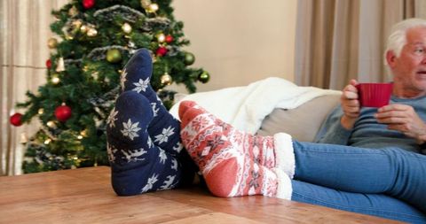 Cozy Moments: Senior Couple Beside Christmas Tree
