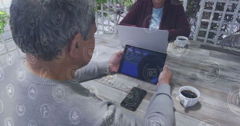 Senior couple engaging with digital technology on patio deck
