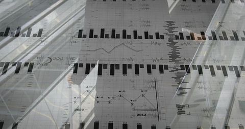 Female Executive Standing in Glass Atrium Holding Folder Overlaid with Charts and Data
