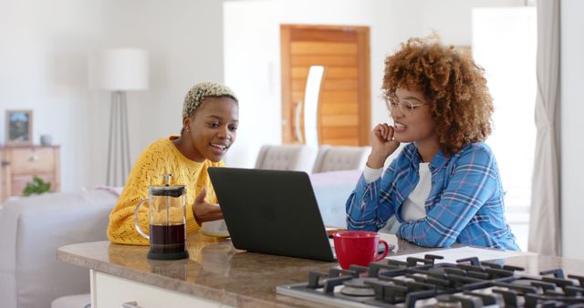 Two Women Working Together on Laptop in Modern Kitchen - Download Free Stock Images Pikwizard.com