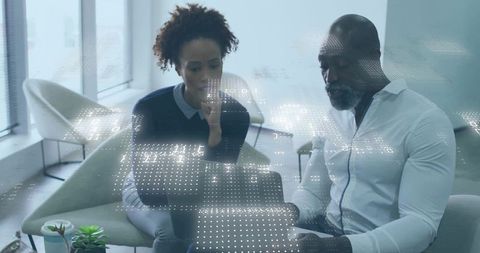 Business professinals collaborating in modern office lounge