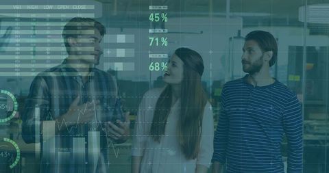 Team Analyzing Digital Data Interfaces in Modern Office