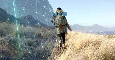 Hiker exploring coastal trail with digital navigation overlay