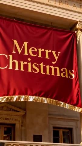 Vertical panning video showing Merry Christmas banner on library facade with gold fringe