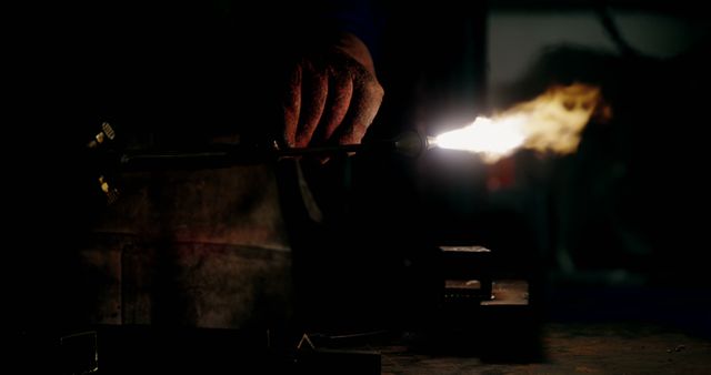 Welder holding welding torch in workshop 4k