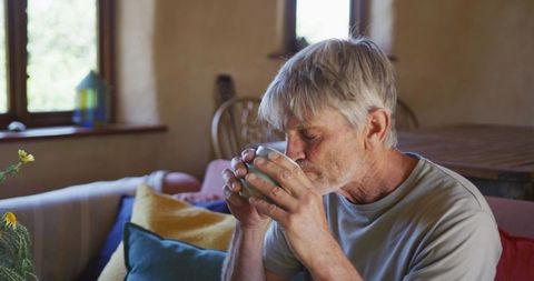 Elderly Man Relaxedly Enjoying Coffee at Home