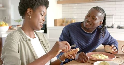 Couple Enjoying Breakfast and Bonding in Modern Kitchen