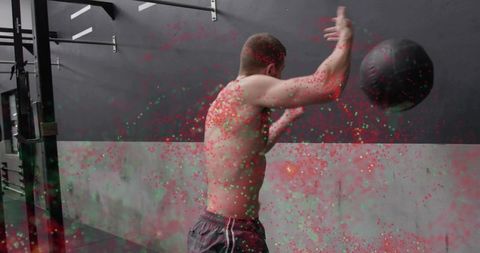 Athletic Man Throwing Medicine Ball in Gym for Strength Training