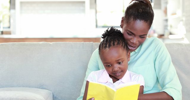 Mother and Daughter Reading Together on Couch - Download Free Stock Images Pikwizard.com